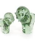 Two clear glass lion sculptures made from recycled glass, with smooth and polished finishes