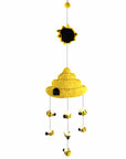 A handmade felt mobile featuring a beehive with bees buzzing around, in yellow, black, and white colors, with a sun and moon at the top.
