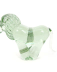 Side view of a clear glass lion sculpture made from recycled glass, with a smooth and polished finish.