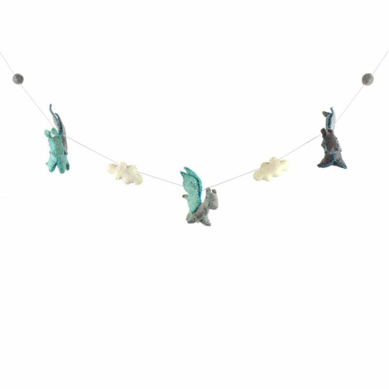 A hand-crafted felt garland featuring multicolored dragon shapes and pom poms strung along a thread
