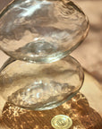 Two glass bowls stacked on a wooden surface with a blurred background