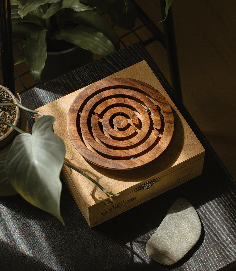 Wooden labyrinth puzzle on a wooden box