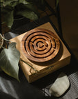 Wooden labyrinth puzzle on a wooden box