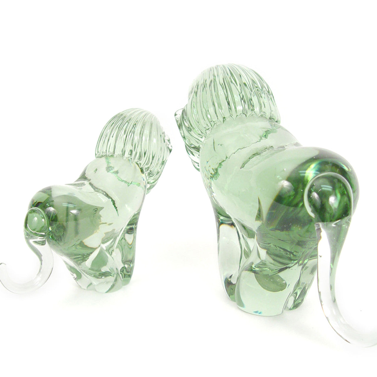 The back of two clear glass lion sculptures made from recycled glass, with a smooth and polished finishes
