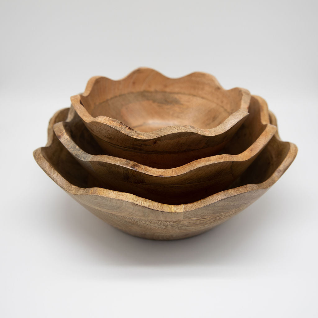 Set of three wooden bowls of different sizes on a white background