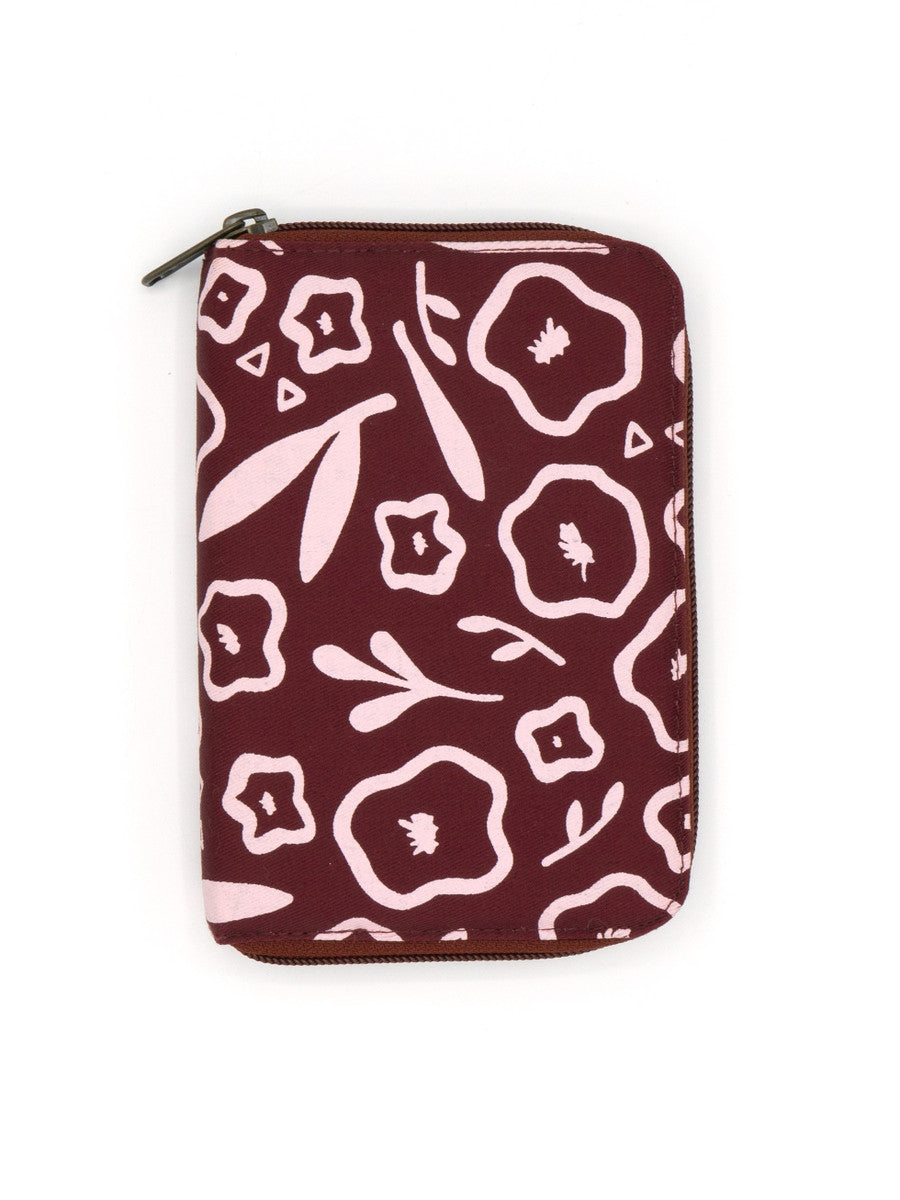 A zippered jewelry travel organizer with a red and multicolor floral pattern, closed and displayed flat.