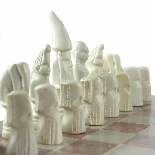 Hand-carved soapstone Maasai chess set on a 14-inch square board, with pieces in pink and white soapstone zoomed in on the white soapstone pieces.