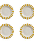Four white ceramic plates with yellow striped rims on a white background