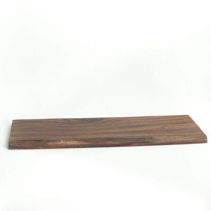 A rectangular acacia wood serving board with a live edge accent, displaying beautiful rich wood grain