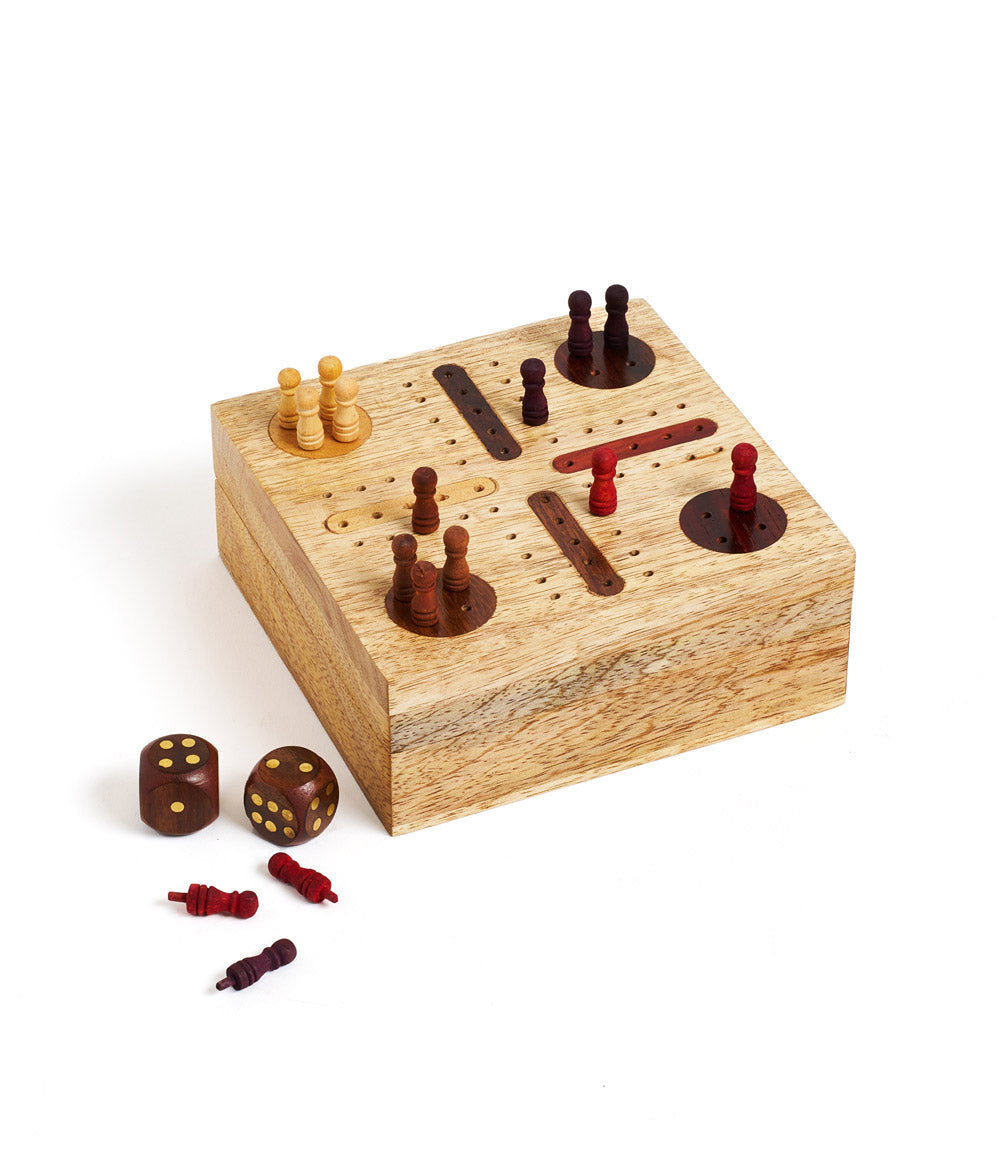 A hand-carved wooden Pachisi game set with a hinged lid, game peg pieces, and dice.