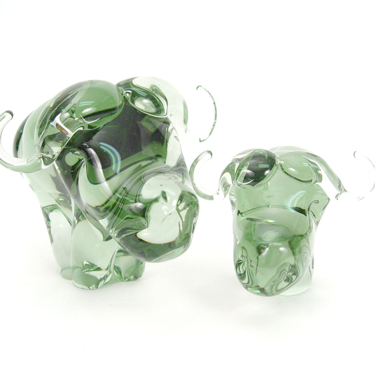 Two glass buffaloes on a white background
