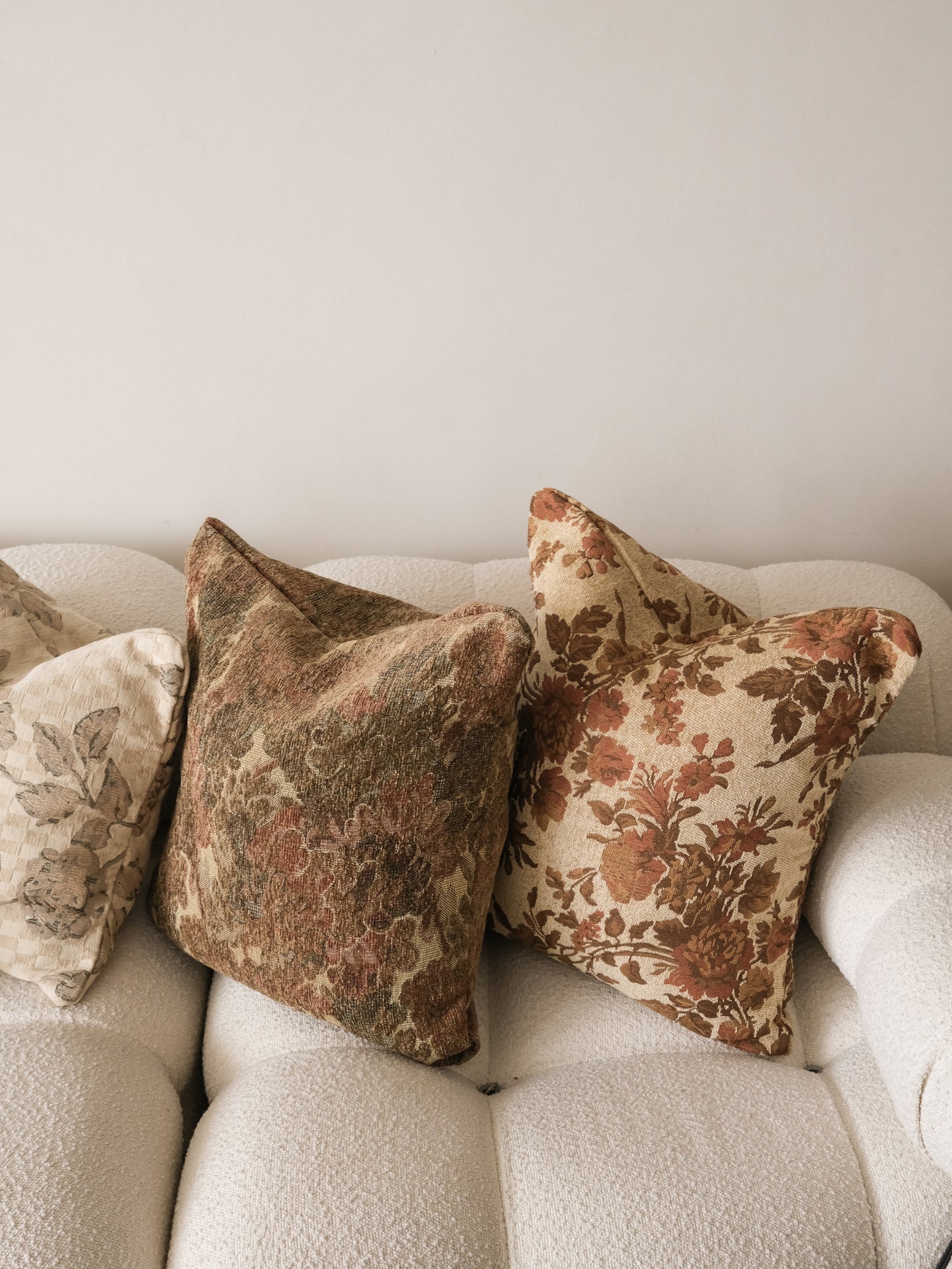 Decorative pillows on a sofa with a neutral background