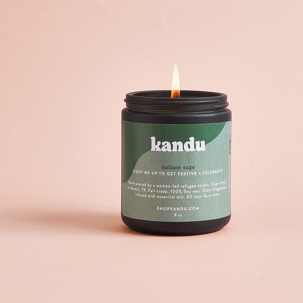 Kandu candle with a green label on a beige background
