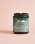 Kandu candle with a green label on a beige background