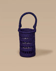 An Iridescent wine tote made from elephant grass, featuring an open weave design and a handle for carrying.