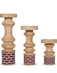 Three wooden candle holders with decorative bases on a white background