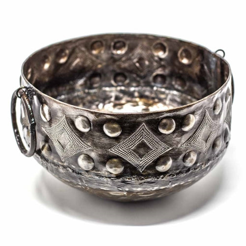 A silver-colored, round metal container with geometric patterns and round handles, crafted from recycled material