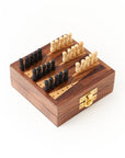 A wooden backgammon game set with black and white pegs arranged on the board with a white background.