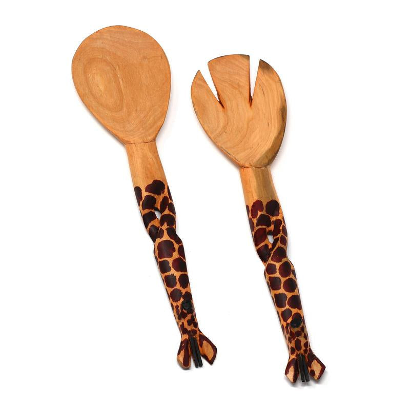 A pair of hand-carved wooden salad servers with giraffe patterns on the handles