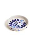 A round ceramic incense holder with hand painted blue floral patterns on a white background.
