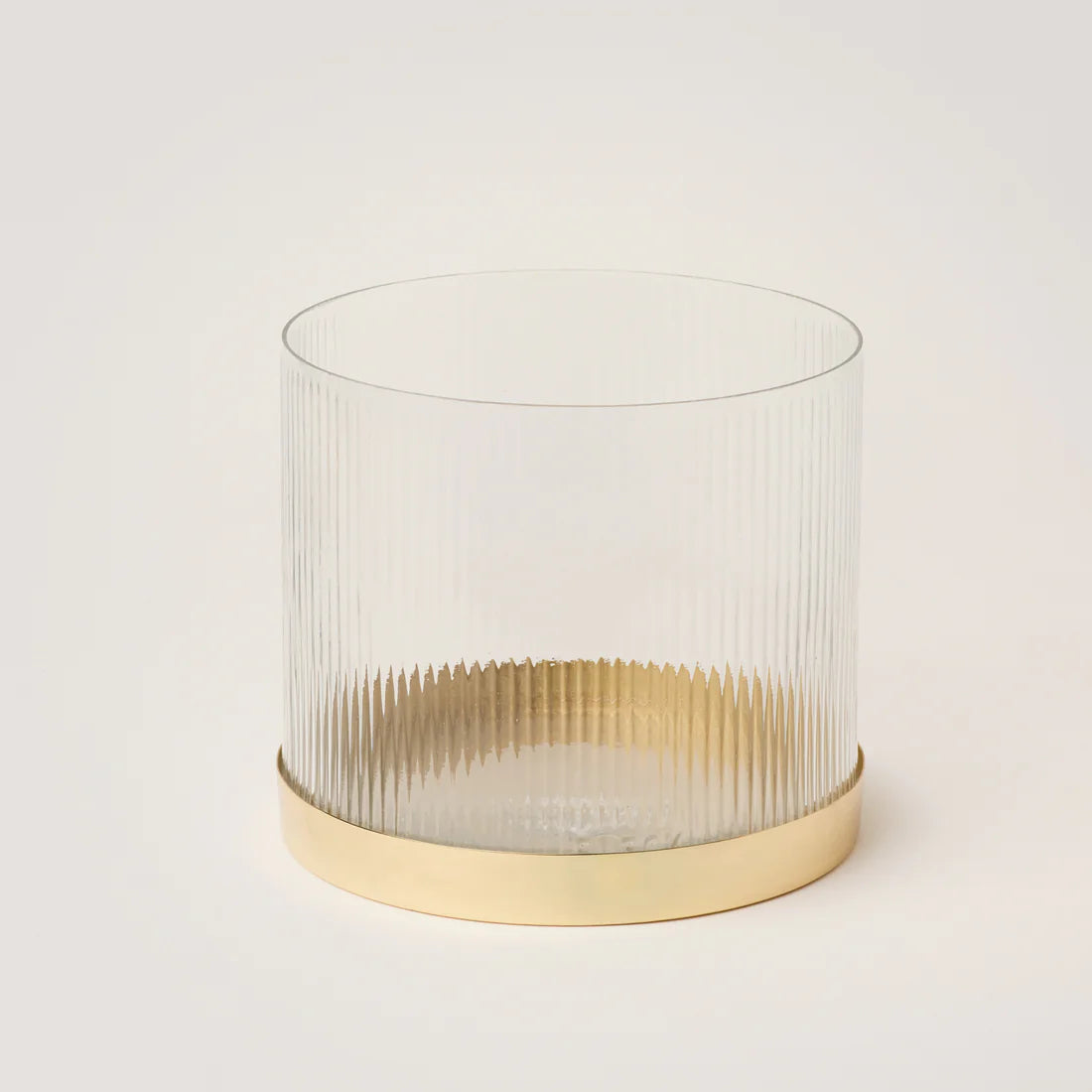 A clear glass vase with fluted sides and a ribbed edge, featuring a gold-colored rim and base.