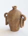 A brown terracotta clay vessel with a spherical base and side handles, displaying a textured finish.