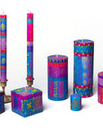 Colorful candle set with geometric patterns on a white background