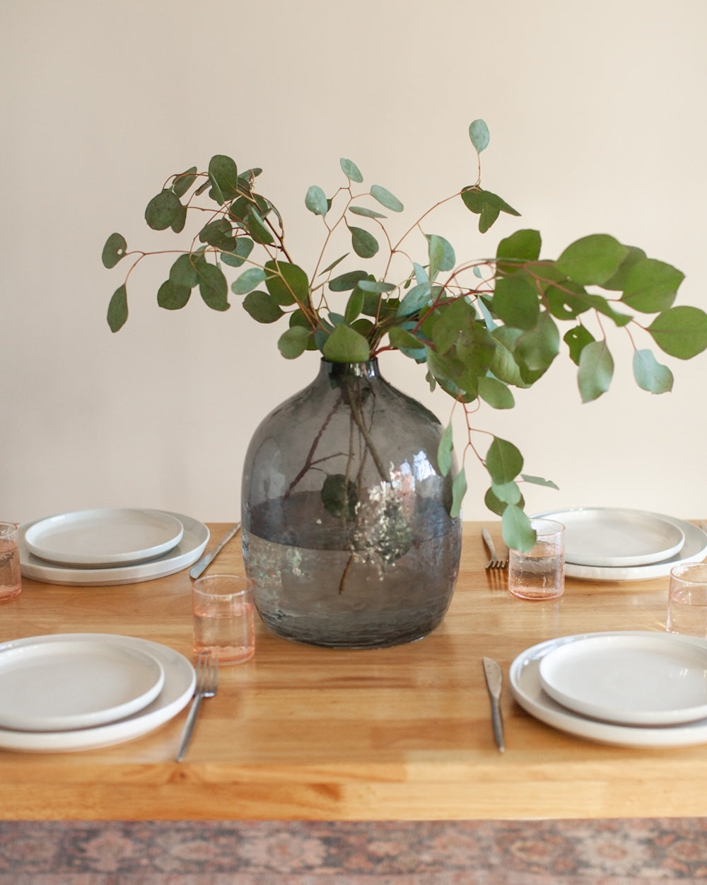 Decorative vase with greenery on a table setting