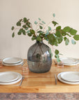 Decorative vase with greenery on a table setting