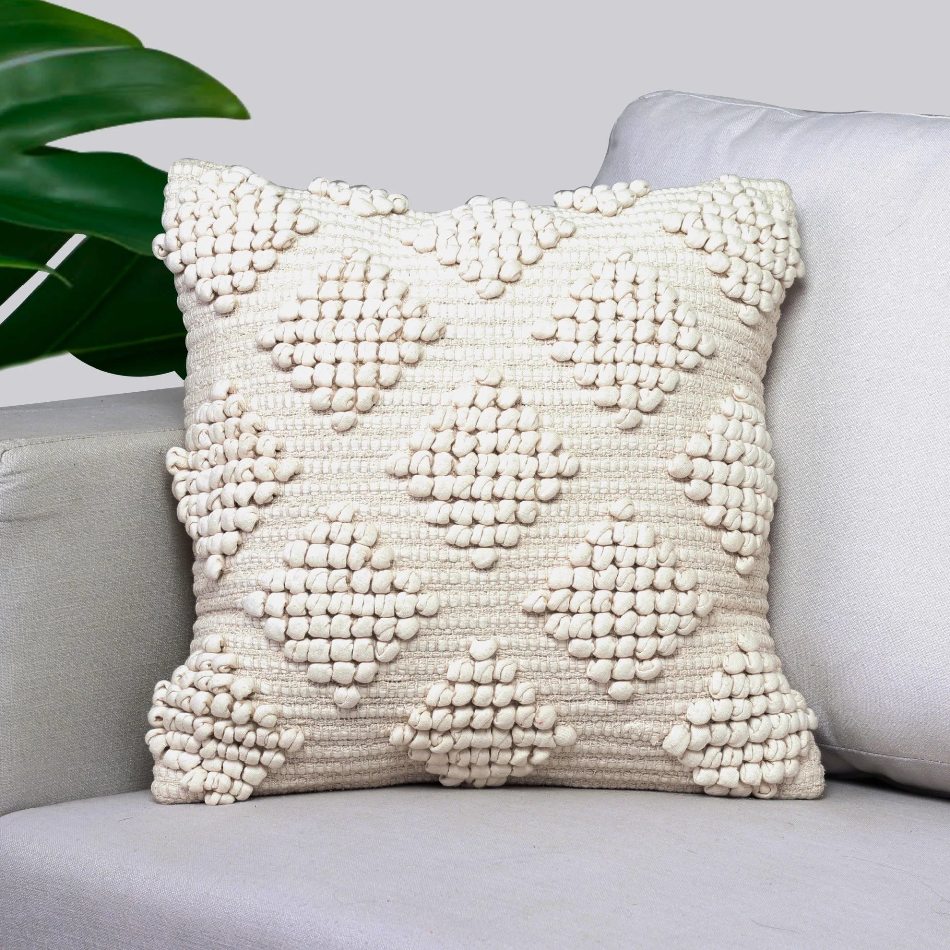 Decorative pillow with textured pattern on a gray sofa