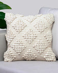 Decorative pillow with textured pattern on a gray sofa