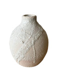 Textured ceramic vase on a white background