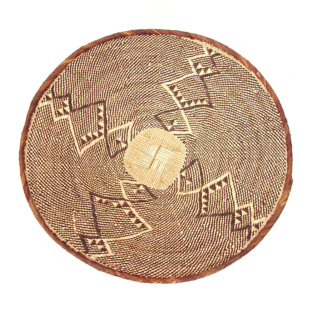 A large, handcrafted basket with a herringbone pattern and a coiled rim, made from natural fibers in a brown color