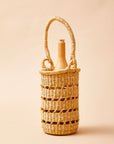 A beige wine tote made from elephant grass, featuring an open weave design and a handle for carrying.