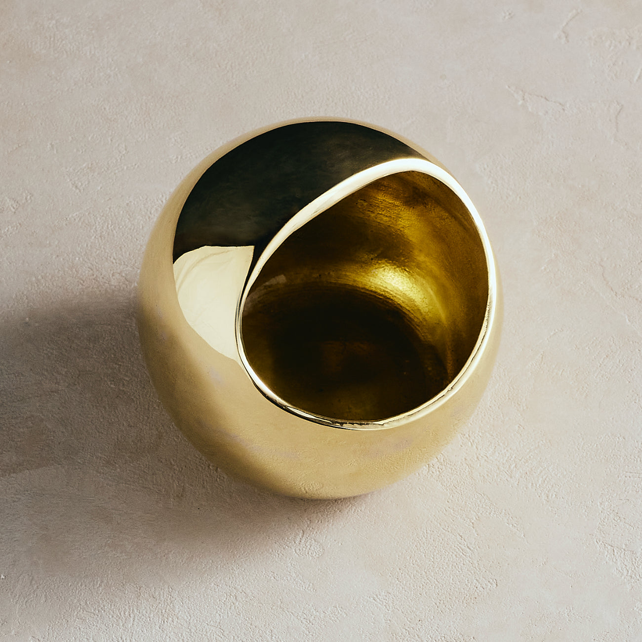 Gold decorative salt cellar on a beige background