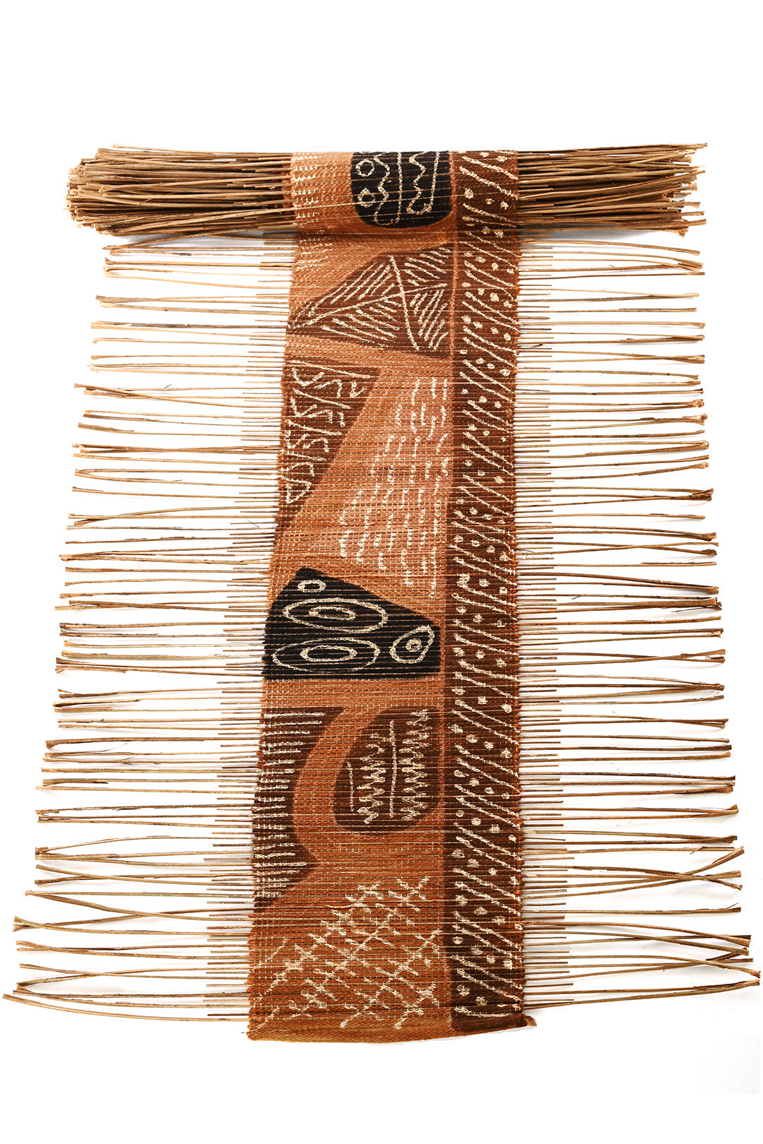 A decorative table runner made from dried twigs and cotton cord with traditional mudcloth geometric patterns in earthy tones