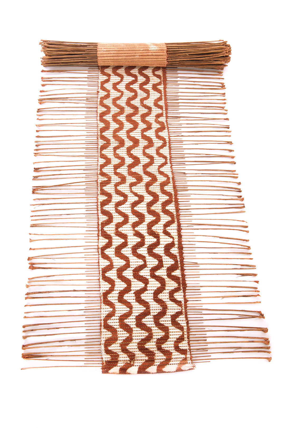 A decorative table runner featuring a geometric pattern with brown and white stripes, made from dried twigs and cotton cord