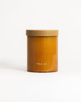 A brown cylindrical soy wax candle in a reusable glass jar with a lid, labeled 'FIELD KIT'.