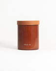 A brown soy wax candle in a reusable glass jar with a lid, labeled 'FIELD KIT'.