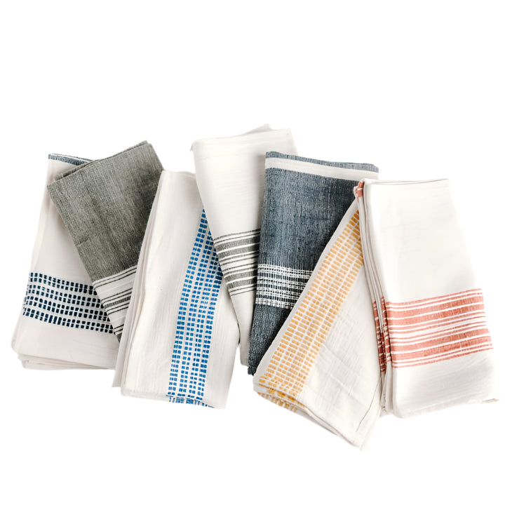 A collection of folded cotton napkins featuring various striped patterns in different colors
