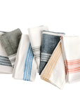 A collection of folded cotton napkins featuring various striped patterns in different colors