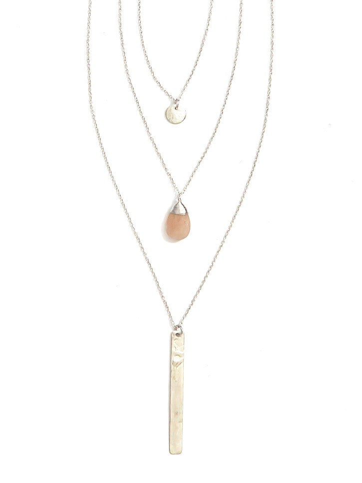 A silver multi-strand multi-way pendant necklace with a pink chalcedony centerpiece stone, displayed against a white background.