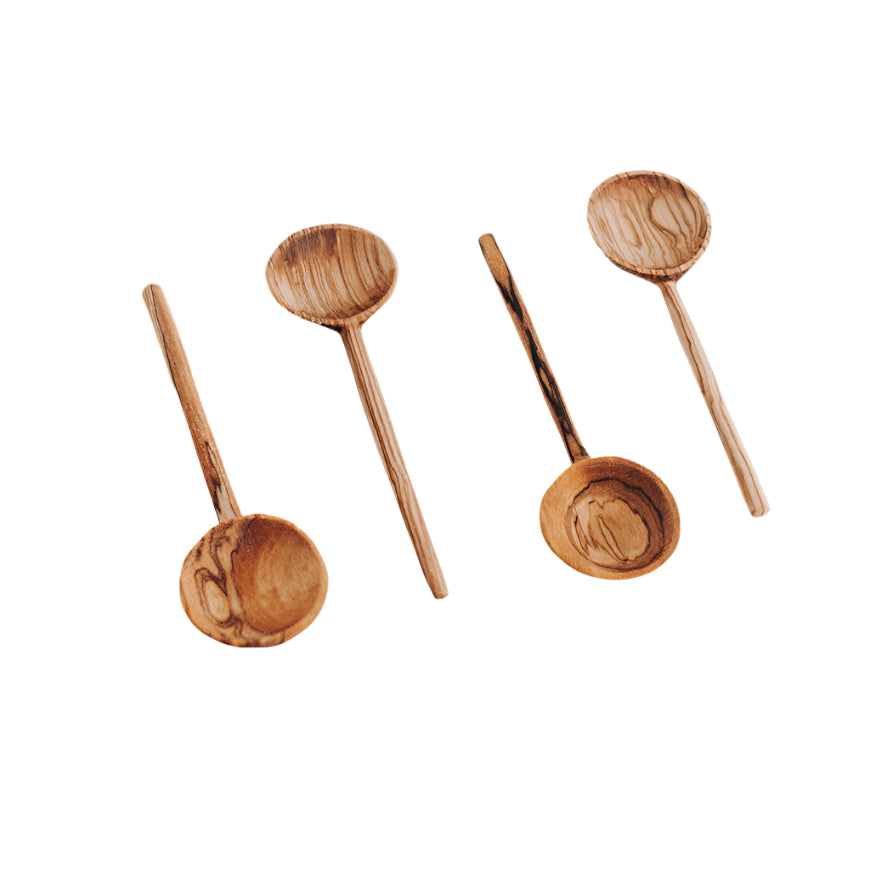 A set of four hand-carved olive wood coffee spoons, each with a unique grain pattern, displayed on a white background