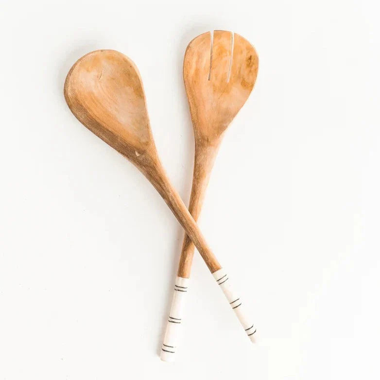 A pair of salad servers with striped patterns, featuring wooden heads and handles with what appears to be batiked designs