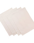 A set of four beige rustic placemats made with upcycled denim and cotton, displayed on a neutral background