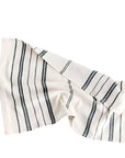 A white cotton tea towel with blue stripes and a visible hand-spun texture