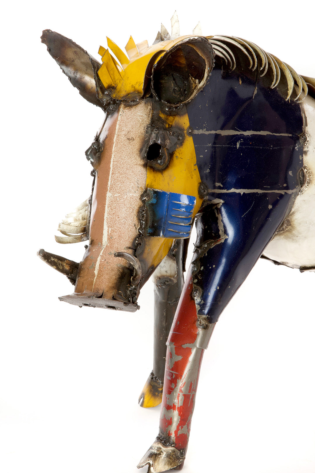 Colorful wart hog sculpture made from recycled materials on a white background
