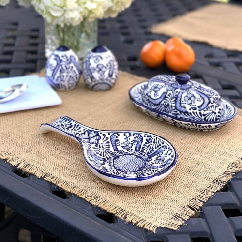 Handmade ceramic spoon rest displayed on a kitchen counter.