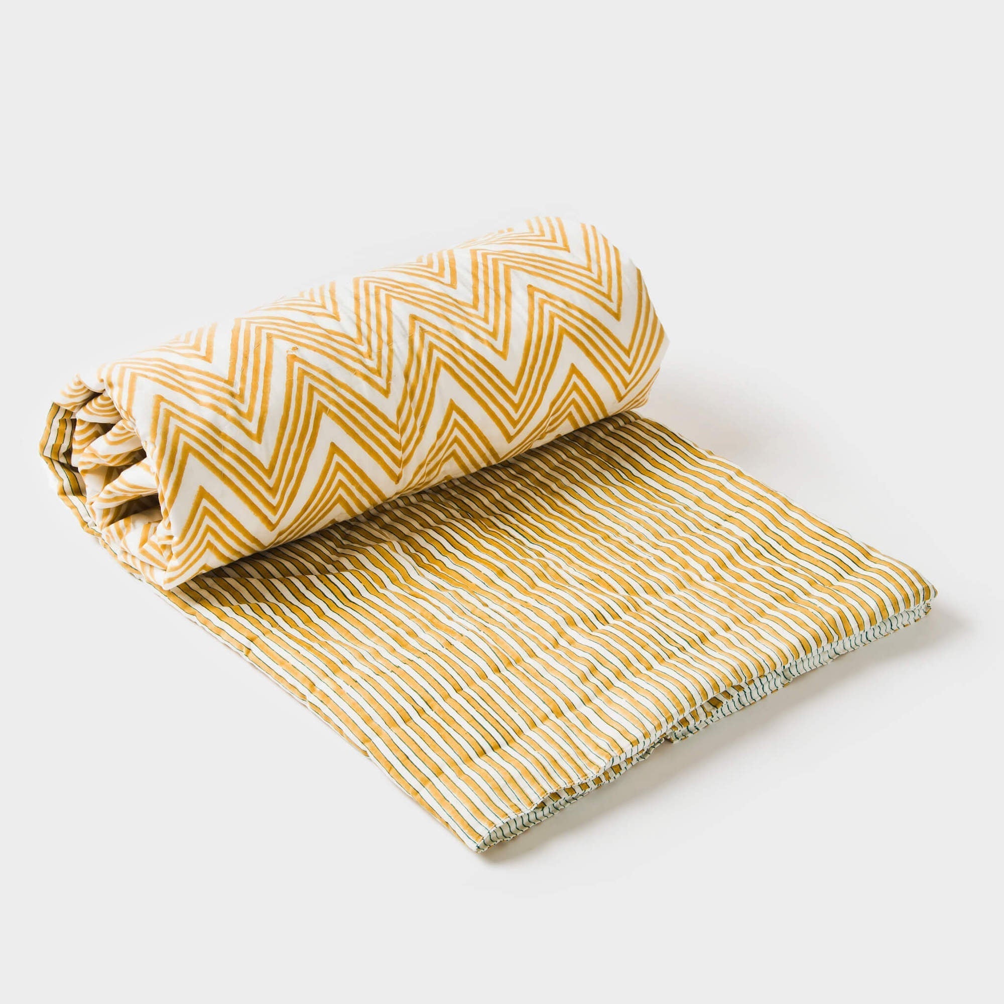 Brown and yellow throw blanket with a white zigzag design, draped for a cozy and stylish home accent.
