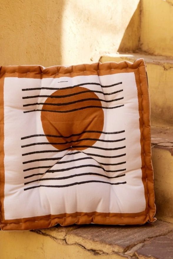 Handmade soft cotton floor cushion with a sun design shown on steps - floor cushion collection at Better World Bio